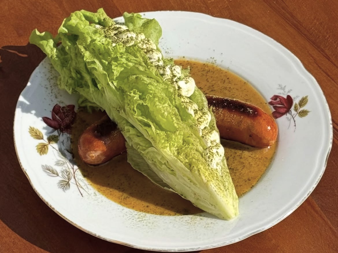 Serbian sausage with Dorion sauce and a wedge of romaine lettuce